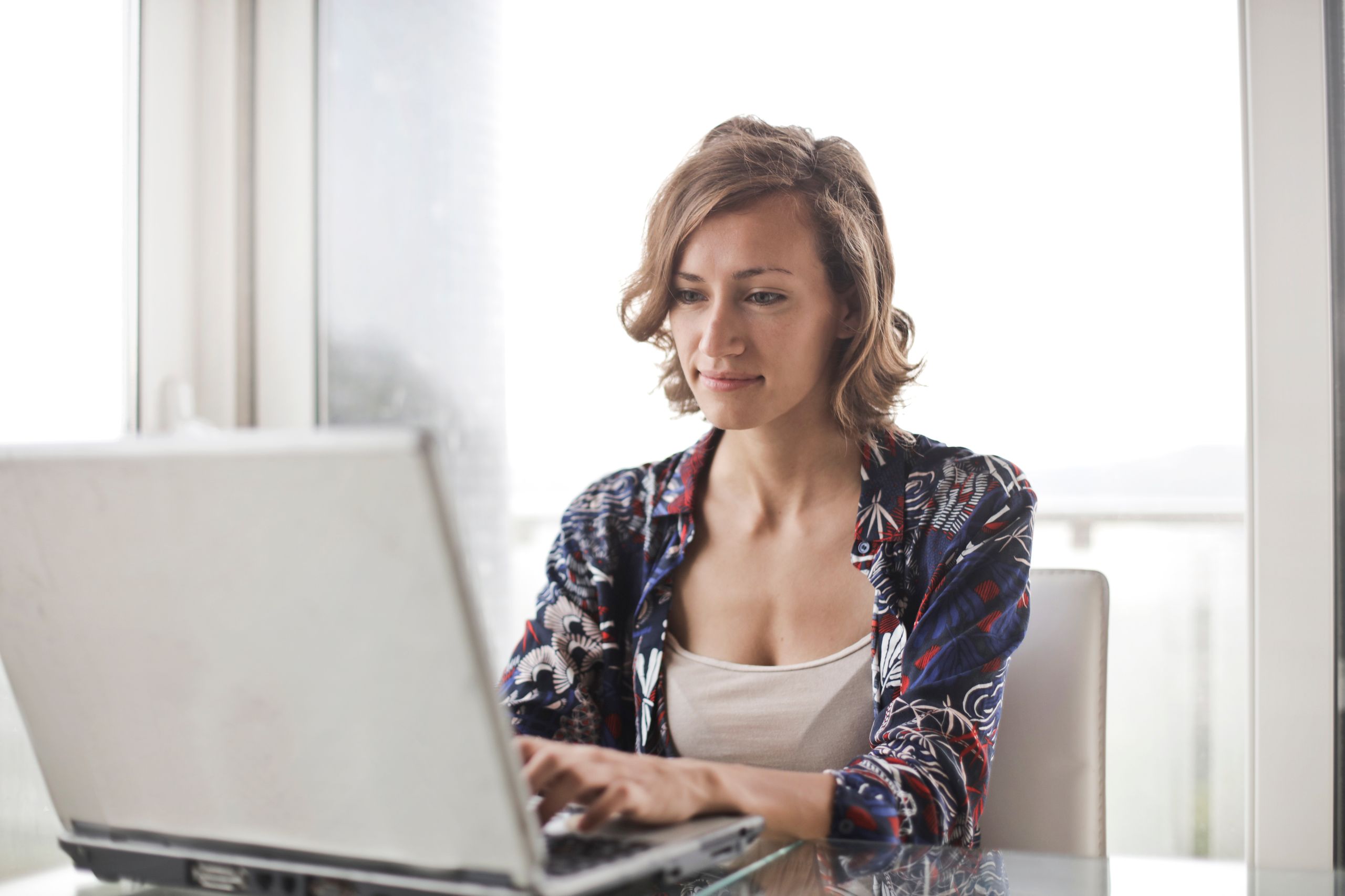 Woman reviewing content pillars and planning a content strategy on her laptop